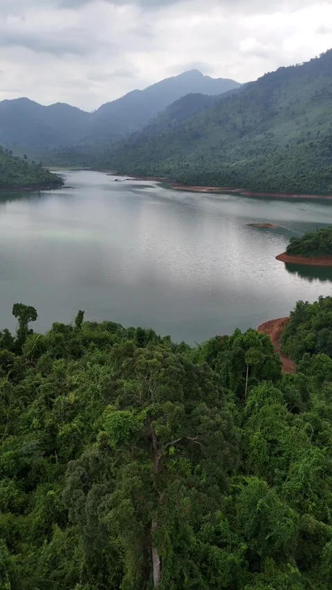 Fog Floating Over Verdant Jungle and Mountain Lake in Hue, Vietnam Stock Footage 335846149