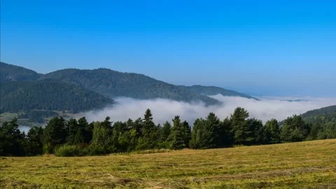 Fog floating in the valley between hills Stock Footage 132253695