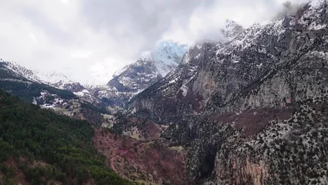 Fog Flow Over Snowy Mountain Valley – 4K Aerial Drone Reverse Stock Footage 331714288