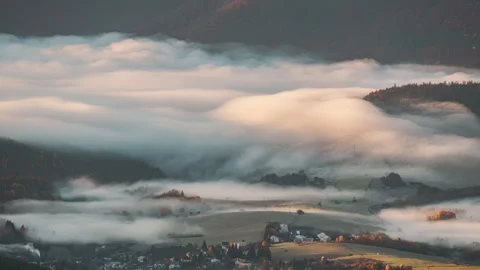 Fog flowing over landscape as sun is rising Stock Footage 320370595