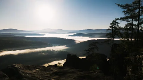 Fog flowing over river, forest in mountains in morning Video stock 311484365