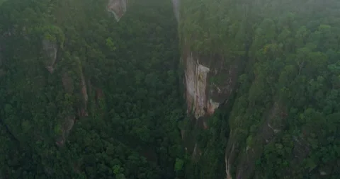 Fog Flowing Through Mountain Cliffs Captured by Cinematic Drone Stock Footage 329657727