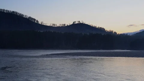 Fog flowing through mountains and forest, river in the foreground Video stock 89197202