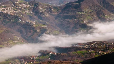 Fog Flows Above Mountain Town. Timelapse Stock Footage 316703048