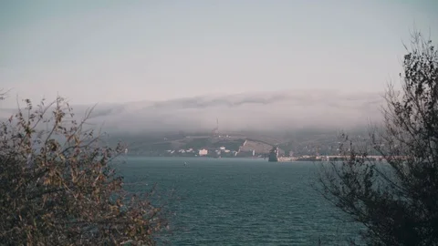 The fog goes down the mountain above the sea Stock Footage 127799988