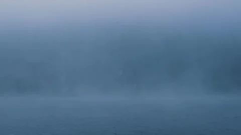 Fog hovering over lake with at dawn Stock Footage 288242566