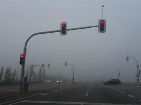 Fog intersection with the lights on red Stock Photos