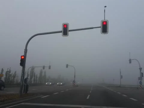 Fog intersection with the lights on red Stock Photos