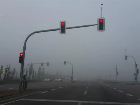 Fog intersection with the lights on red Stock Photos