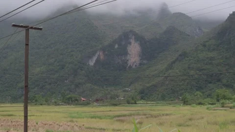 Fog limestone mountains over rice fields and scattered homes in Ha Giang valley. Stock Footage 336719152