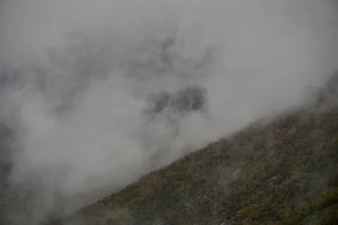Fog in the mountains at sunset time Stock Photos