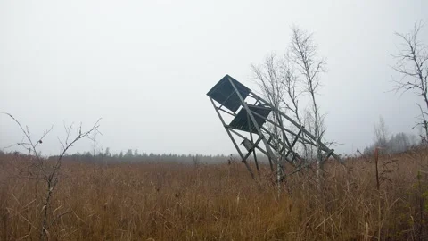 Fog moving at flood meadow with fallen birdwatching tower time-lapse Stock Footage 158113005