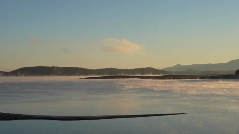Fog Moving over the Mountain Lake at Sunrise Video stock 257914347