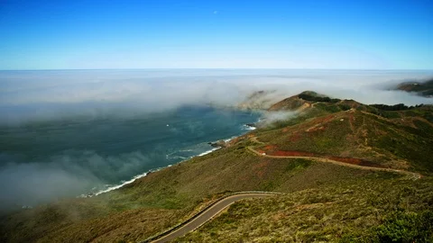 Fog moving over a winding road near a beach. Stock Footage 88342541