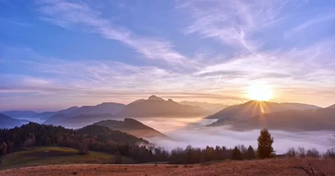 Fog moving in a valley in a mountain landscape at sunset. Stock Footage 167380392