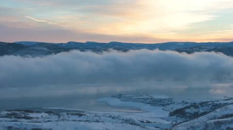 Fog or Clouds over a mountain lake Stock Footage 14946674