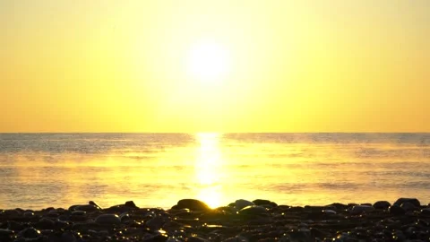 Fog over the sea at dawn on a pebble beach Stock Footage 231978323