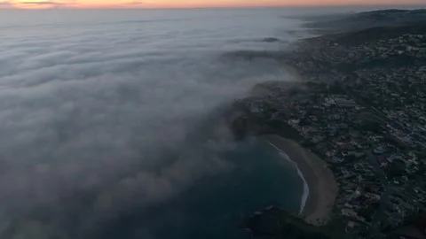 Fog Overtaking Coastline at Sunset 2 Stock Footage 340579556