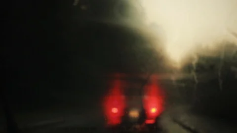 Fog rain flows and wipers on the front windshield glass window of car on the Stock Footage 94531306