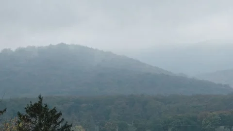 Fog rises in the mountains after rain, mountain landscape in the morning haze. Stock Footage 255380274
