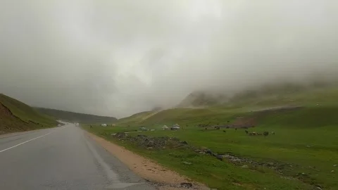 Fog on the road, poor visibility. Traveling by car in Kyrgyzstan Stock Footage 249244422