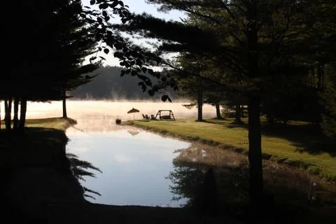 Fog rolling of a lake Stock Photos