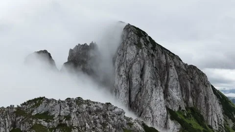 Fog rolling over a dramatic mountain ridge, Dachstein, Austria Stock Footage 319051703