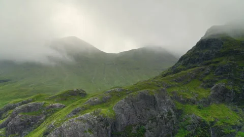 Fog rolling over green mountains in the Scottish Highlands Stock-Footage 336796049