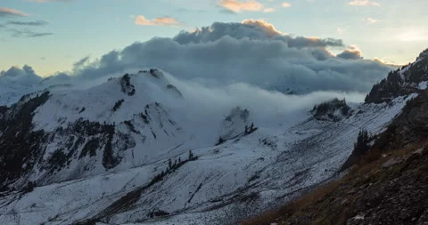 Fog rolling over mountain at sunset Stock Footage 165237600