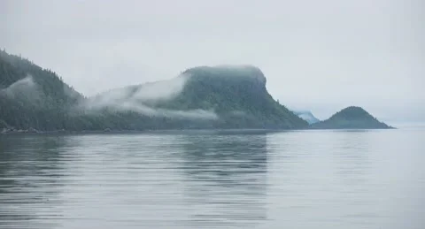 Fog rolling over the mountains and water in Bic National Park, Quebec weather Vídeo Stock 218335622