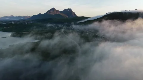 Fog rolling over mountains and road in lofoten islands, norway Stock Footage 317102203