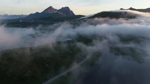 Fog rolling over mountains and lakes in lofoten islands, norway Stock Footage 317102304