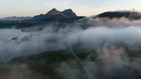 Fog rolling over mountains and fjord in norway at sunset Stock Footage 317102334
