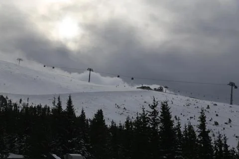 Fog Rolling Over Ski Slope With Mountain Lodge and Lift Fotos Stock