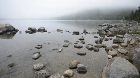 Fog rolling in over stones in a pond. Stock Footage 25588778