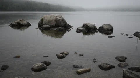 Fog rolling in over stones in a pond. Stock Footage 25588790