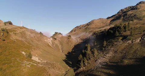 Fog rolling through mountain at sunrise drone aerial 4k Stock Footage 125758808