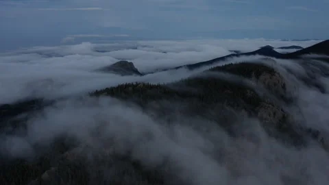 Fog rolls over the mountain peaks in Colorado Stock Footage 247363797