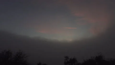 Fog rolls in as the sunsets Stockbeeldmateriaal 165142897