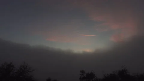 Fog rolls in as the sunsets Stockbeeldmateriaal 165144831