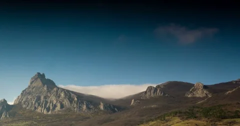 The fog slips down from the mountains Stock Footage 75558380