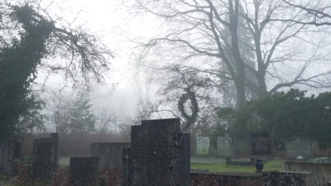 Fog slowly dissolves to reveal a gloomy cemetery Видео 292924710