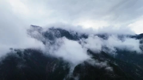 Fog Sweep Across Rugged Mountain Ridges Reverse 4K Stock Footage 331265429