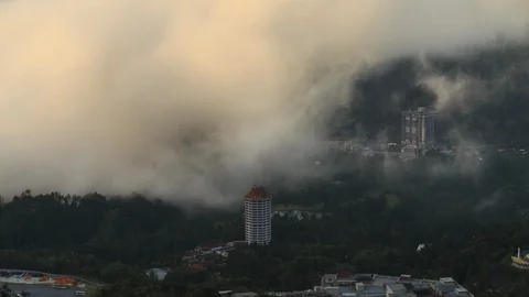 Fog time lapse over buildings and green lushes of highlands at Genting Highlands Stock Footage 105984582