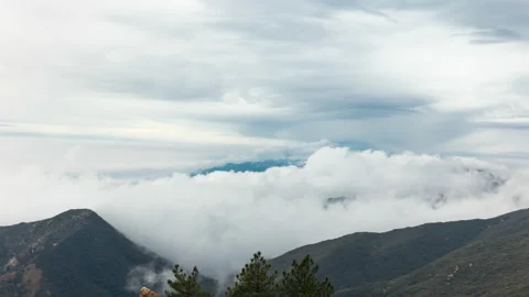 Fog time lapse rolling over mountains 4k 24fps Stock Footage 132865298