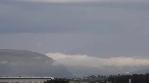 Fog timelapse over river valley with light rays moving across the frame. Stock Footage 113877952
