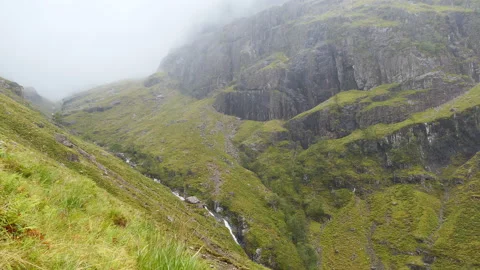 Fog trapped between rocky edges of a mountain. Stock Footage 147013107