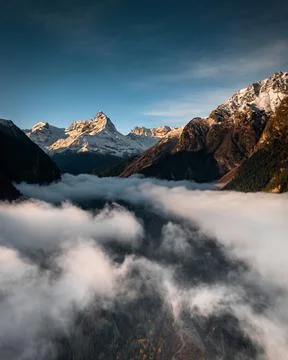 Fog in the valley between the mountains overlooking the beautiful sky Stock Photos