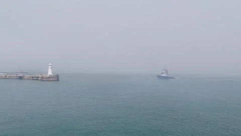 Fogg covered light house a view from Dover UK Stock Footage 246535243