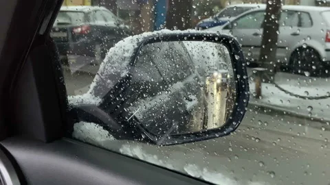 Foggy car window in snowfall winter day with traffic light and pedestrian  Stock Footage 124738149